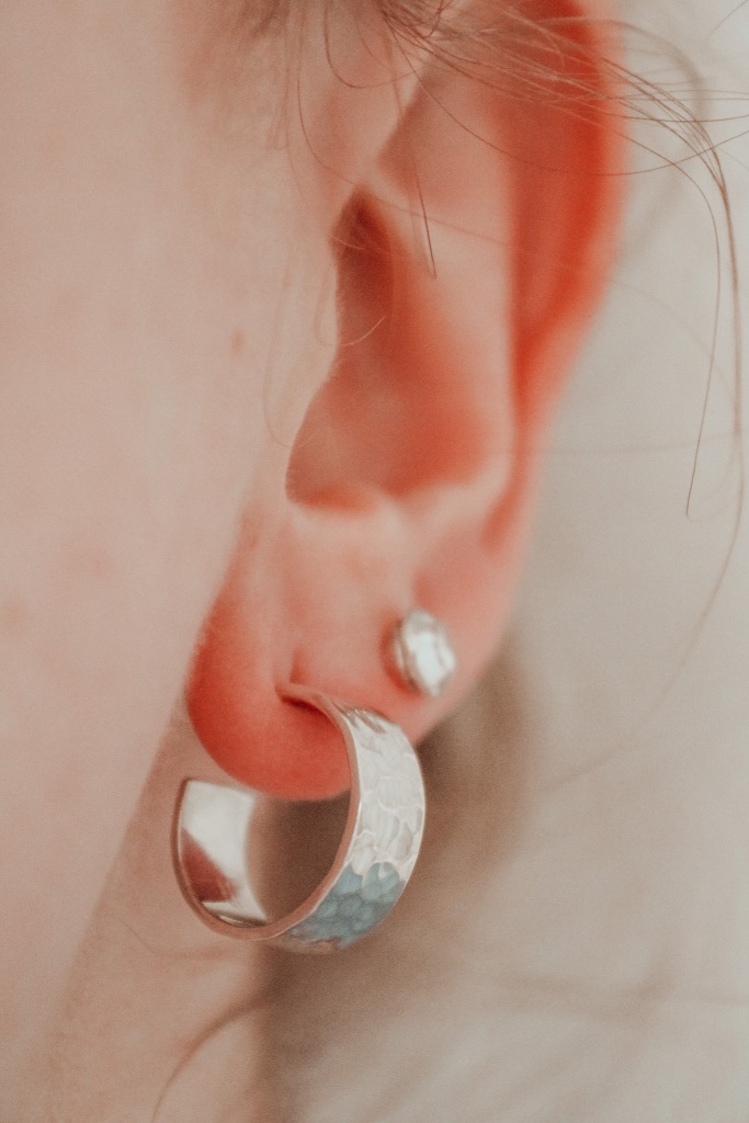 Girl wearing chunky sterling silver hoop earrings